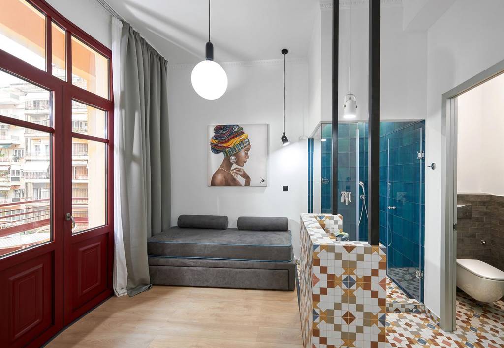 Bedroom with African-portrait art and antique sideboard
