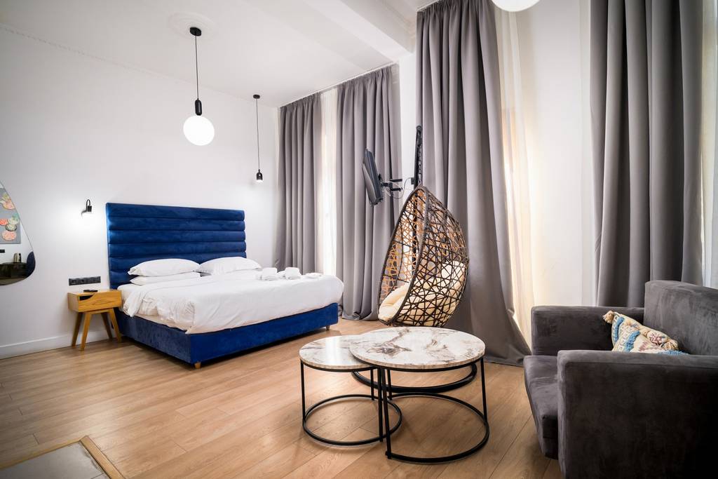 Suite with hanging rattan chair and marble tables